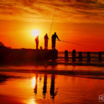 men finishing at sunset on the background of jaffa