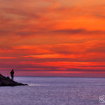 red skies during sunset in the sea shore