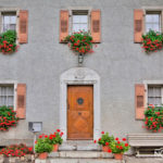 house building with door and windows with flowers