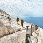 soldiers walking on white cliffs on the mediterranean sea