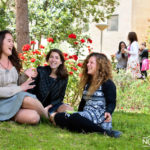 3 girls sitting on the grass and laughing